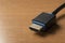 Hdmi high definition multimedia interface cable on wooden table