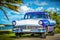 HDR - American 1956 blue Ford Fairlane classic car parked on the Malecon near the beach in Havana Cuba - Serie