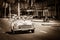 HDR - American Cabriolet vintage car drives with tourists on the main street in Havana Cuba - R