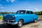 HDR classic car parked under blue sky in Villa Clara Cuba