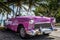 HDR Cuba american pink Oldtimer parked near the beach