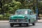 HDR Cuba green american classic car drives on the Malecon Promenade in Havana