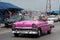 HDR Cuba pink american Oldtimer drives on the Malecon Promenade in Havana