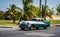 HDR green american classic car with white roof on the street in Cuba