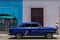 HDR parked blue american classic car in Cuba with a latino