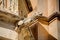 HDR photo of a historic stone gargoyle on the edge of an old house in Mdina city, historic capital of Malta