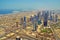 HDR picture of the skyline of downtown Dubai seen from the sky. Skyscrapers and one of the biggest road intersections with the sea