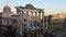 HDR view of the Roman Forum with Septimius Severus triumphal arch and Temple of Saturn, church dome and city skyline in ancient do