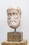 Head of ancient greek statue, bust on white wall