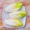 Head of belgian endive chicory on wooden table