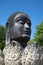 Head of the black Buddha in the Lotus flower. Ancient sculpture on the temple grounds of Wat Thammikarat. Thailand