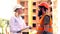 The head of construction discusses details of work with workers on the construction site. A woman in a white helmet