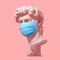 Head Of David In Medical Mask On Pink Background. Concept Of Coronavirus Quarantine.