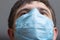 Head of doctor in surgical mask ready to operate and looking straight with confidence, concept of medicine and health,head of