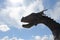 The head of a dragon against the sky. Fragment of the nose of a medieval Viking ship against the blue sky