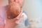 Head of a newborn close up. The father holds in the hands of the infant and copy space. Baby care concept