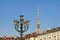 Head of an old fashioned victorian style lampost against a blue sky