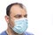 Head of the older man with blue surgical protective mask agains pandemic corona covid-19 virus