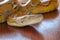 Head python yellow pattern on a table edge. Close up of snake skin texture use for background. Portrait of a Albino reticulated