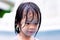 Head shot. Asian beautiful child girl sweet smiling. Kid body wet after playing water in the pool. Happy children funny in summer