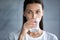 Head shot beautiful woman drinking clean mineral water, holding glass