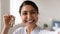 Head shot close up of excited Indian woman showing keys