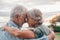 Head shot close up portrait happy grey haired middle aged woman snuggling to smiling older husband, enjoying sitting on bench at