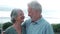 Head shot close up portrait happy grey haired middle aged woman snuggling to smiling older husband, enjoying tender moment at park