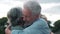 Head shot close up portrait happy grey haired middle aged woman snuggling to smiling older husband, enjoying tender moment at park