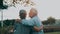 Head shot close up portrait happy grey haired middle aged woman snuggling to smiling older husband, enjoying tender moment at park