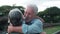Head shot close up portrait happy grey haired middle aged woman snuggling to smiling older husband, enjoying tender moment at park