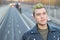 Head shot of handsome green haired young man outdoors