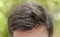 Head shot of man dark messy hair with bokeh background