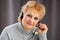 Head shot mature woman looking at camera and talking, grandmother chatting with relative online, making video call