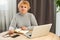 Head shot mature woman looking at camera and talking, grandmother chatting with relative online, making video call