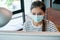 Head shot and portrait of Asian woman with hygiene mask work in front of monitor of computer during work at home