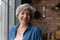 Head shot portrait of cheery elderly woman pose indoors