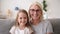 Head shot portrait grandmother and granddaughter making video call