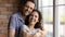 Head shot portrait overjoyed young couple hugging, standing at home