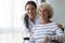 Head shot portrait smiling caregiver and disabled older woman