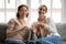 Head shot portrait smiling mature mother and grownup daughter knitting