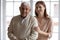 Head shot portrait smiling older man with grownup daughter