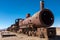 A head on shot a rusting steam trains and carriages that are slowly rot away at the train graveyard just outside of