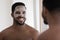 Head shot smiling African American man enjoying skincare procedure