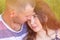 Head shot of a young affectionate romantic couple of lovers. Close up portrait of an attractive brunette girl and guy with closed