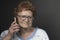 Head and shoulder portrait of an over 90-year-old lady smiling with a mobile