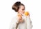 head and shoulders portrait of attractive beautiful young caucasian woman isolated on white studio shot drinking orange juice