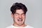 Head And Shoulders Studio Shot Of Man Pulling Faces And Smiling At Camera