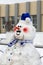 Head and torso of a decorated snowman on a winter street