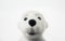 Head of toy polar bear made of felted wool on white background